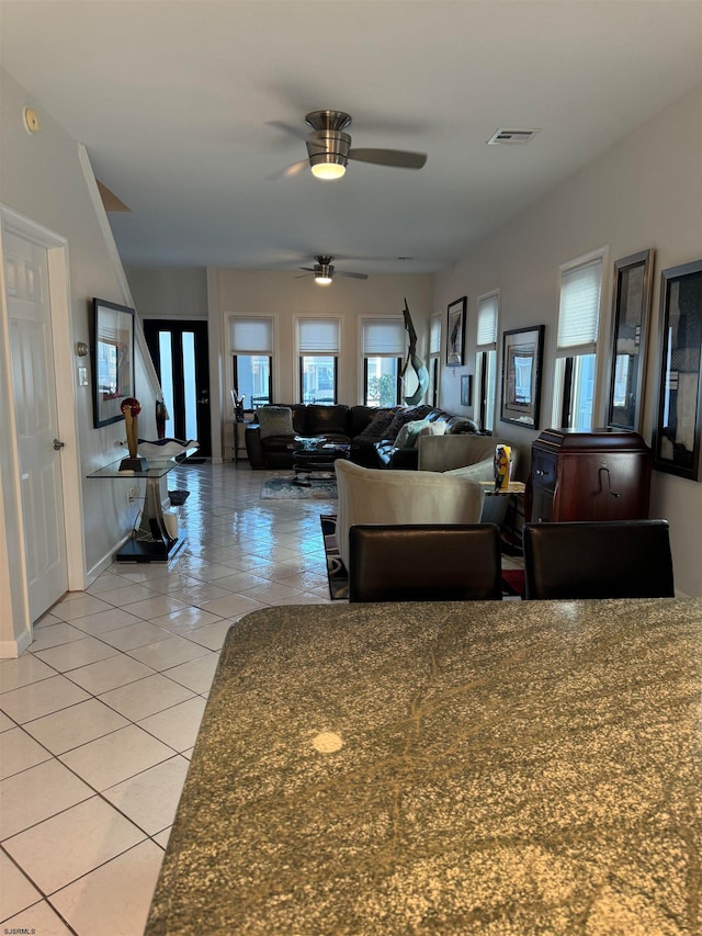 living room featuring ceiling fan and light tile patterned flooring