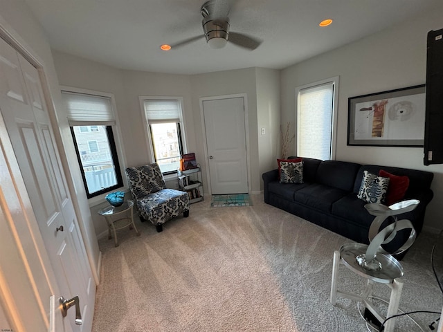 carpeted living room with ceiling fan and a wealth of natural light