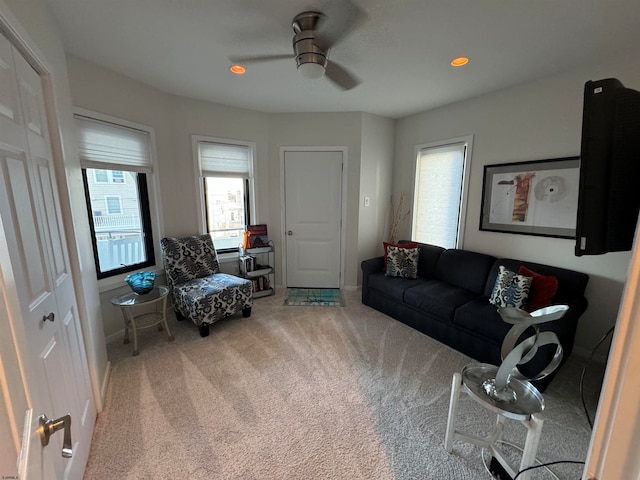 living room featuring ceiling fan and carpet