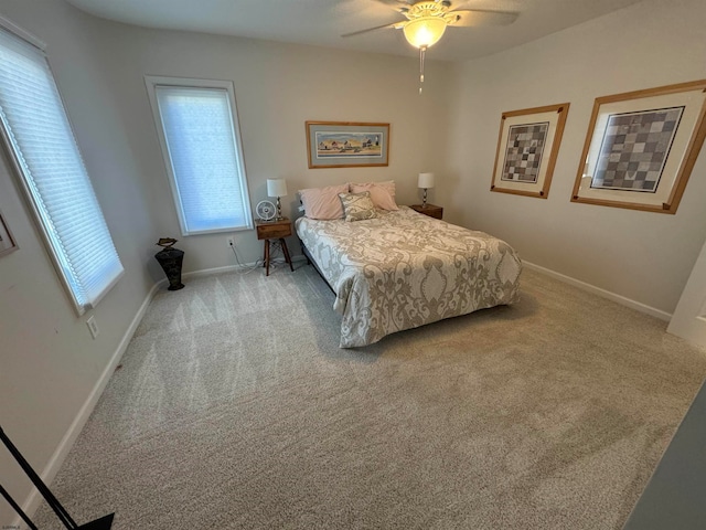 bedroom with ceiling fan and light colored carpet