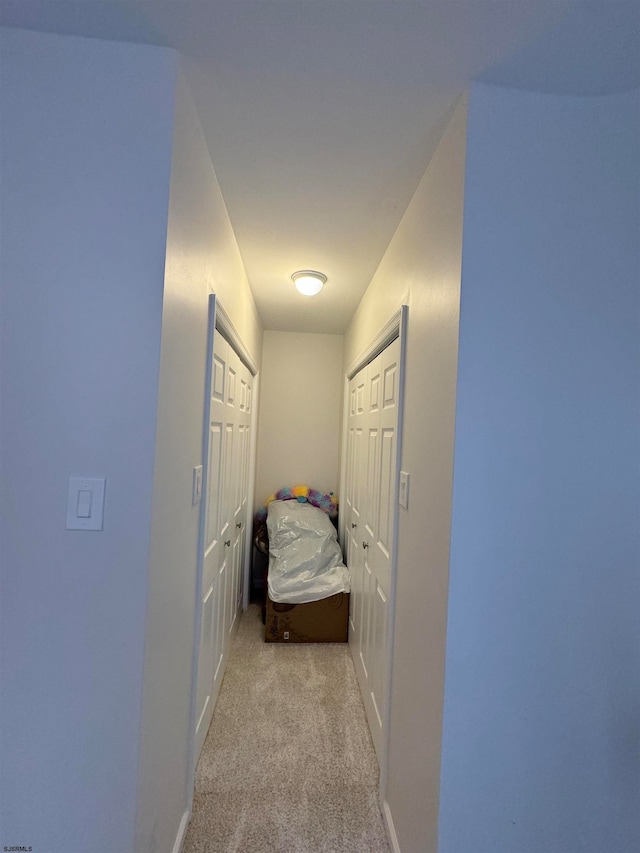 hallway with light colored carpet