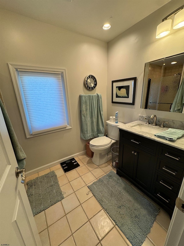 bathroom featuring tile patterned floors, vanity, an enclosed shower, and toilet