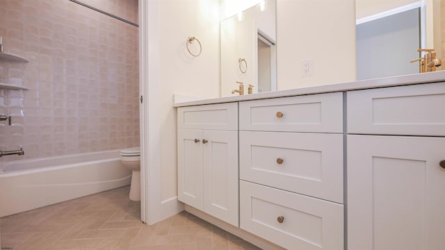 full bathroom with tiled shower / bath combo, toilet, and vanity