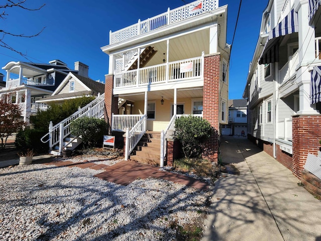 view of front facade with covered porch and a balcony