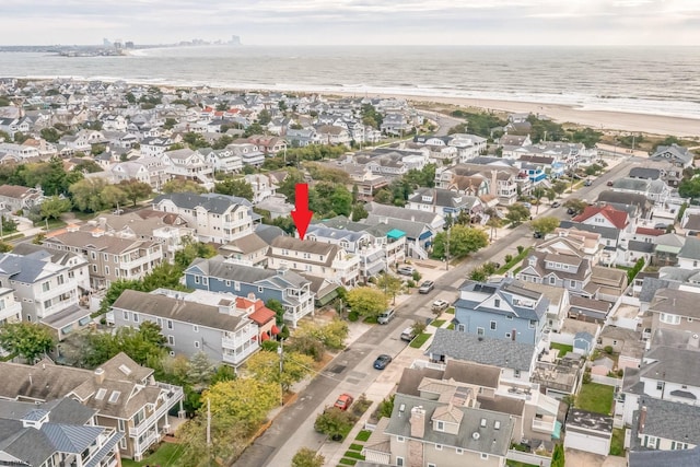 aerial view featuring a water view and a beach view