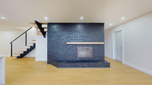 unfurnished living room with a fireplace and light hardwood / wood-style flooring