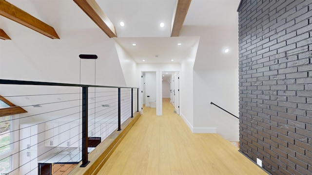 hallway featuring light hardwood / wood-style flooring, lofted ceiling with beams, and mail boxes