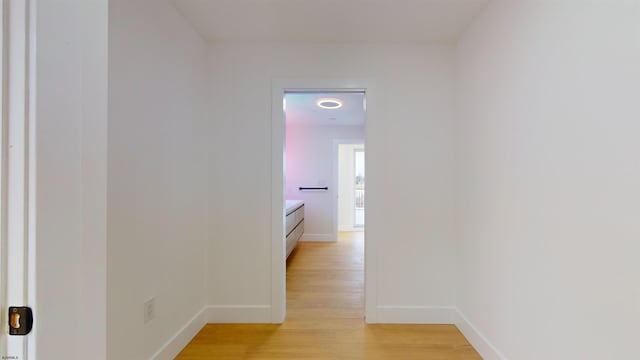 corridor with light hardwood / wood-style floors