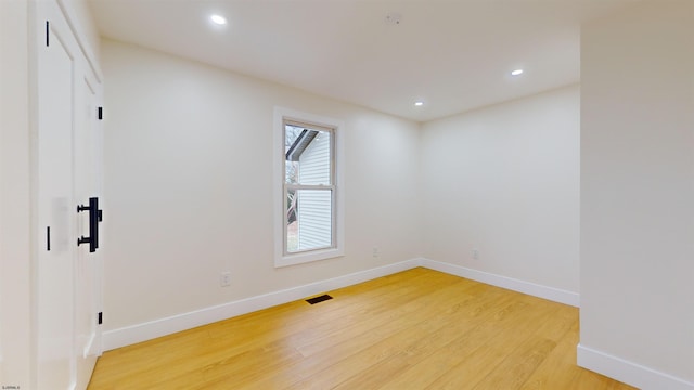 spare room featuring wood-type flooring