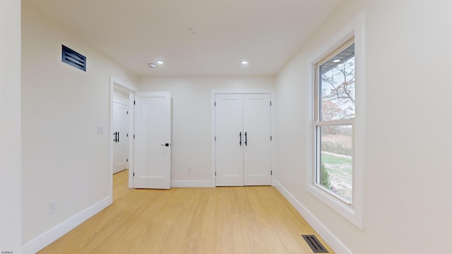 unfurnished bedroom featuring light wood-type flooring