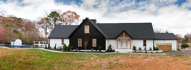 view of front of property with a garage and a front lawn