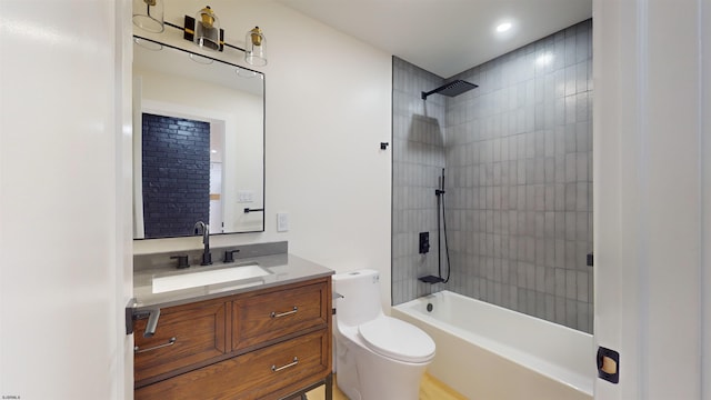 full bathroom with tiled shower / bath, vanity, and toilet