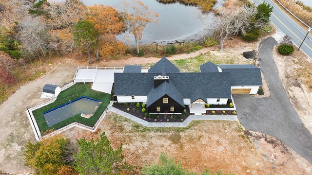 birds eye view of property with a water view