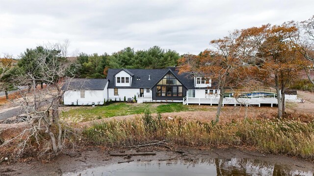 rear view of property featuring a water view