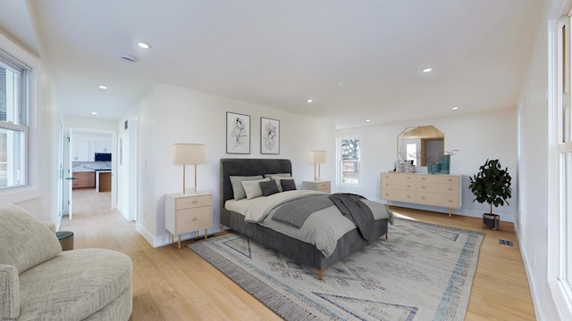 bedroom featuring multiple windows and light wood-type flooring