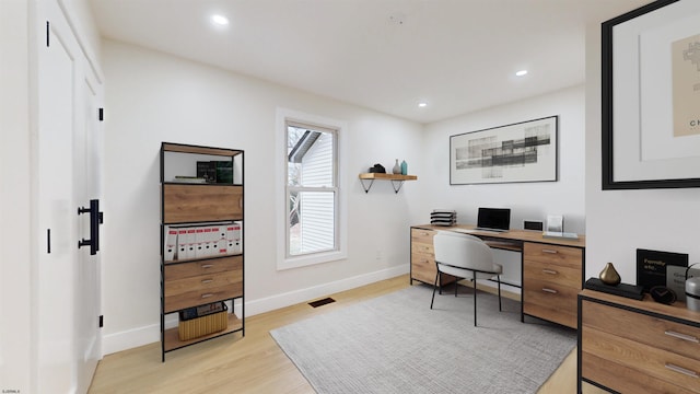 office with light wood-type flooring