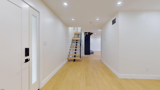 corridor with light wood-type flooring