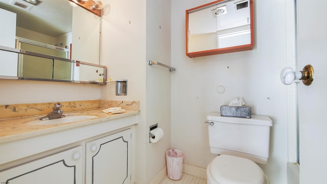 bathroom with tile patterned floors, vanity, and toilet