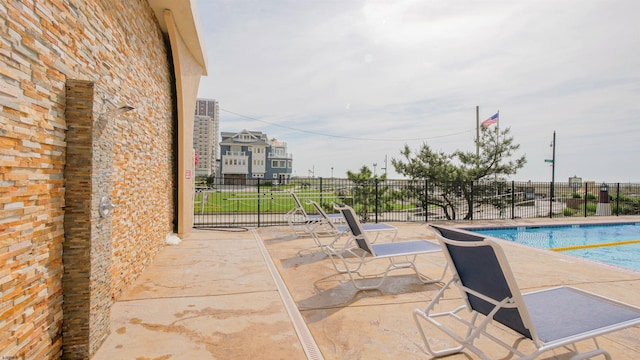 view of patio featuring a community pool