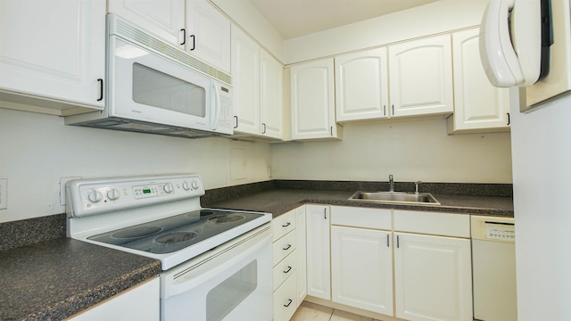 kitchen featuring white appliances, white cabinetry, and sink