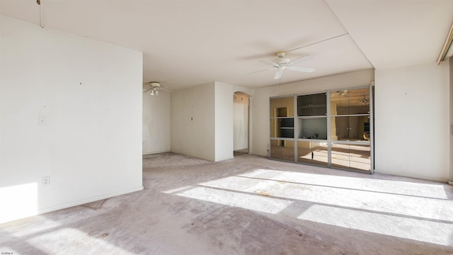 empty room featuring ceiling fan and light carpet