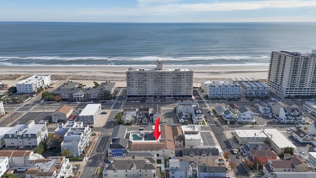 birds eye view of property featuring a view of the beach and a water view