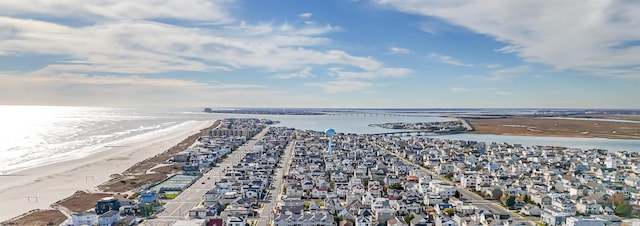 birds eye view of property featuring a beach view and a water view