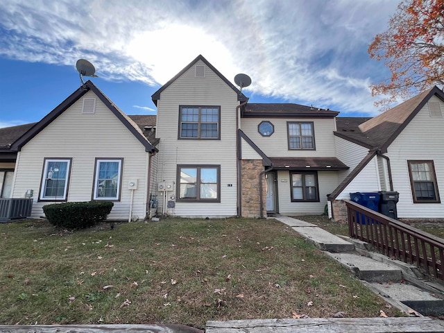 view of front of home featuring central AC and a front yard