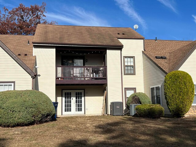 rear view of property with french doors, a yard, and central air condition unit