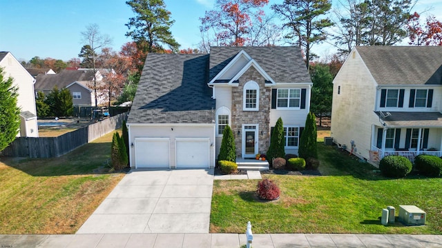 view of front of house featuring cooling unit, a front yard, and a garage