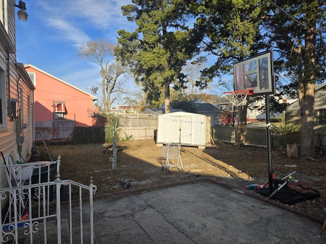 view of yard with a storage unit and a patio area