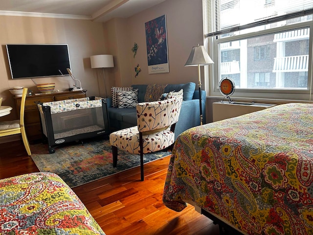 bedroom with wood-type flooring and ornamental molding