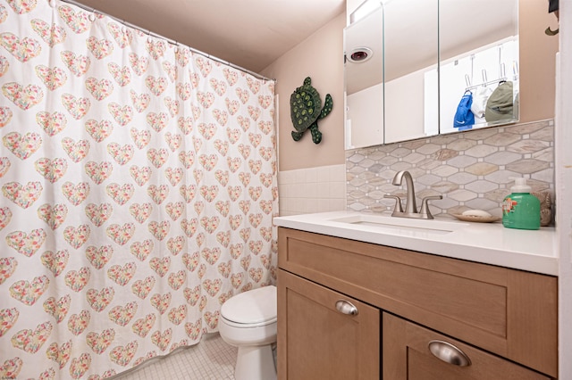 bathroom featuring tile patterned floors, vanity, toilet, and decorative backsplash