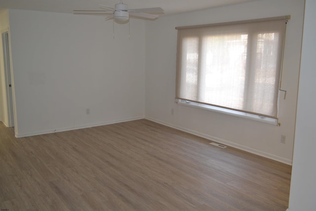 unfurnished room with ceiling fan and wood-type flooring