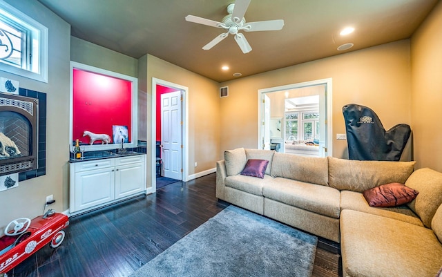 living room featuring ceiling fan, dark hardwood / wood-style flooring, and sink