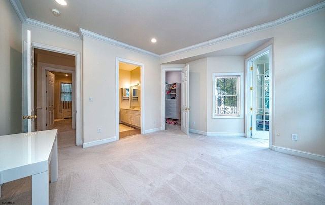 unfurnished bedroom with light carpet, ensuite bath, and ornamental molding