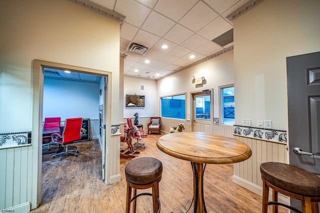 interior space with hardwood / wood-style floors and a drop ceiling