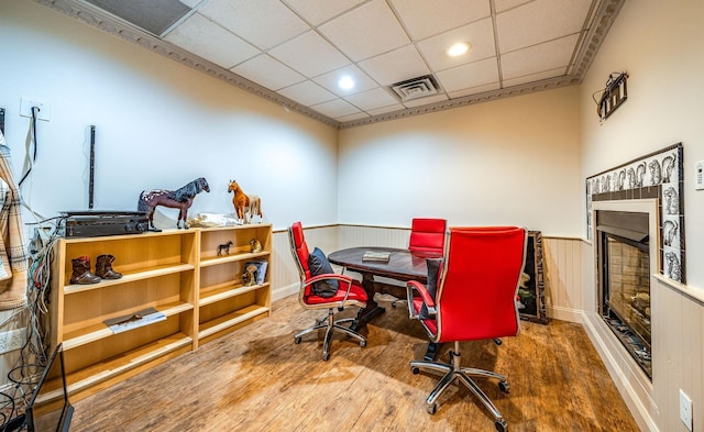 office area with a drop ceiling and wood-type flooring