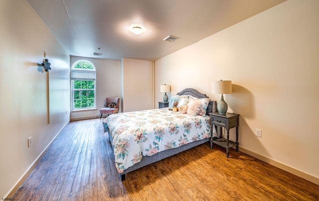 bedroom with hardwood / wood-style flooring