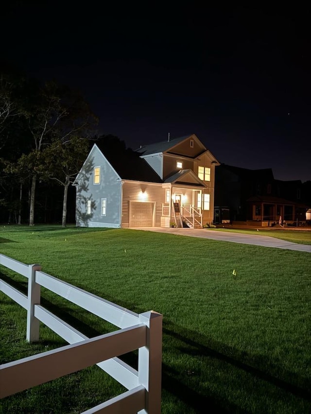 view of front of home featuring a yard and a garage