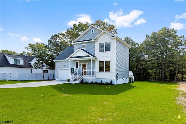 view of front of home with a front yard and a garage