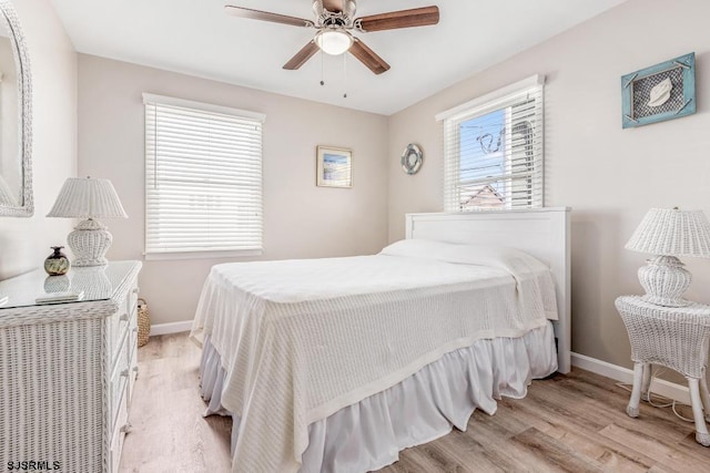 bedroom with ceiling fan and light hardwood / wood-style flooring