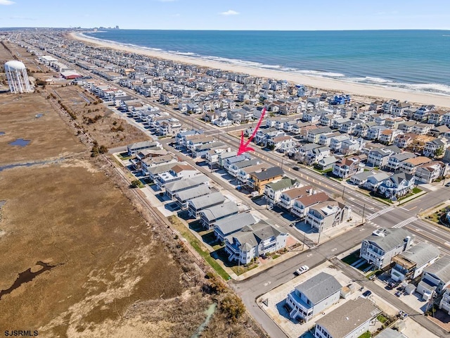 birds eye view of property featuring a water view and a view of the beach