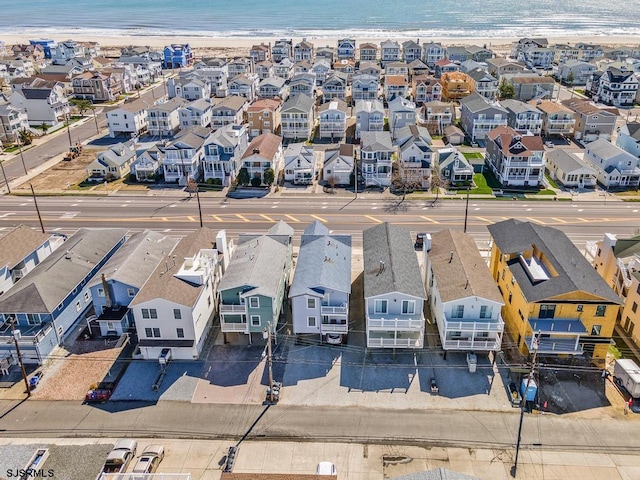 bird's eye view featuring a view of the beach and a water view