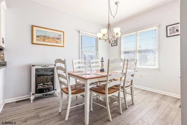 dining area featuring a chandelier and light hardwood / wood-style floors