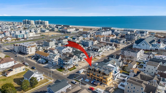 birds eye view of property featuring a beach view and a water view