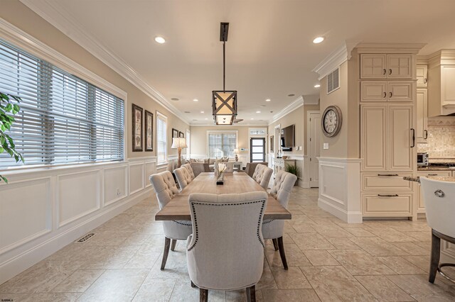 dining room featuring crown molding and a wealth of natural light