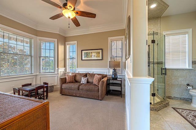 living room featuring light carpet, crown molding, and ceiling fan