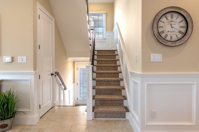 stairway featuring tile patterned flooring and a wealth of natural light