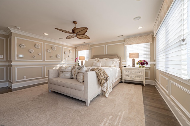 bedroom with crown molding, ceiling fan, and hardwood / wood-style flooring